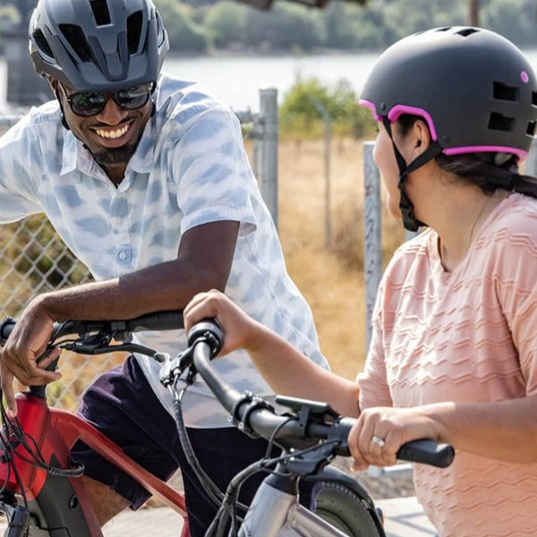 Two people smiling with their Schwinn Helmets on.