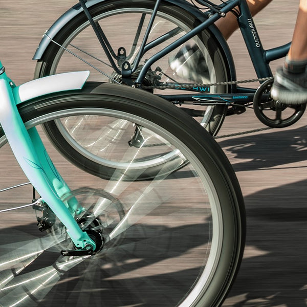 Close-up of two e-bikes going by.