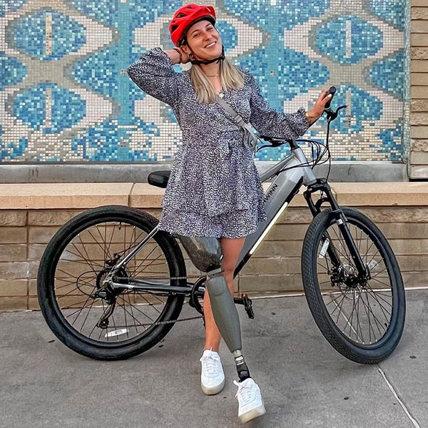 Lacey Henderson standing with a Schwinn electric bike.