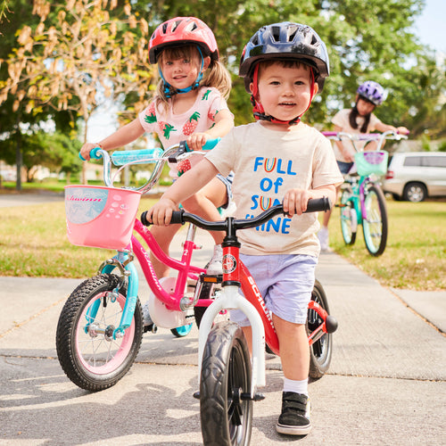 Kids enjoying their new Schwinn Helmets and Bikes on a sidewalk